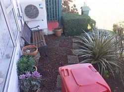 Small garden weeding and trimmed bush